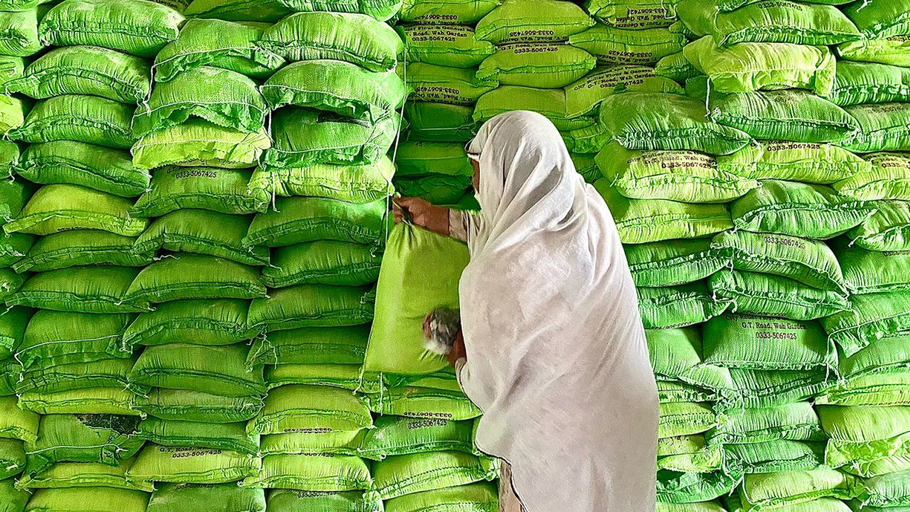 A woman takes a bag of free flour at a government run distribution center in Islamabad.