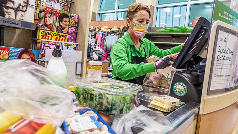 A woman checking out groceries